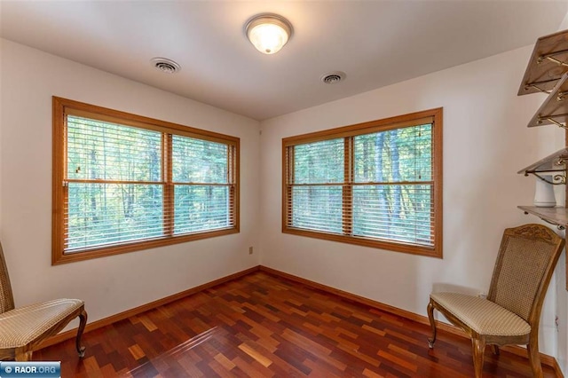 sitting room with dark hardwood / wood-style floors and a healthy amount of sunlight