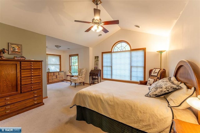 bedroom featuring ceiling fan, light carpet, and vaulted ceiling