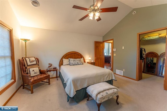 carpeted bedroom featuring multiple windows, vaulted ceiling, a spacious closet, and a closet