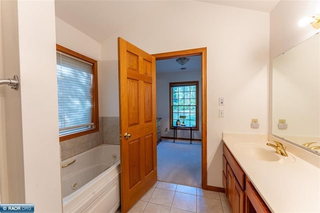 bathroom featuring vanity, tile patterned flooring, and a bath