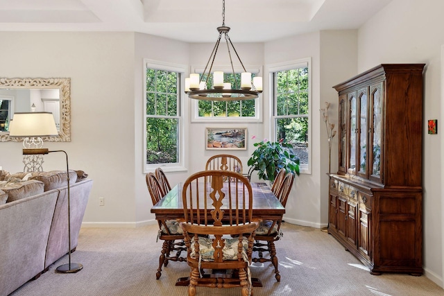 carpeted dining room with a notable chandelier