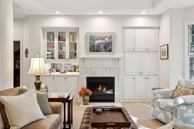 carpeted living room featuring a premium fireplace