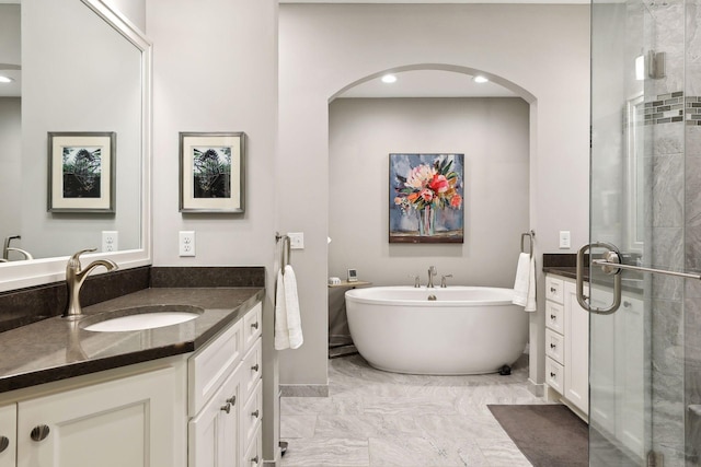 bathroom featuring separate shower and tub and vanity