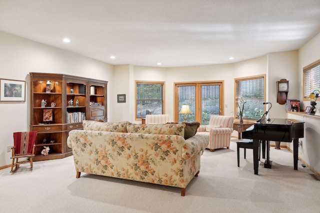 living room featuring radiator, plenty of natural light, and light colored carpet