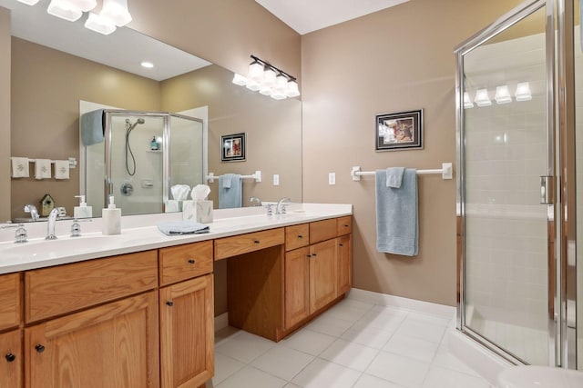 bathroom featuring tile patterned flooring, a shower with shower door, and vanity