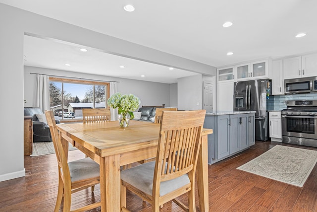 dining area featuring dark wood-type flooring, recessed lighting, and baseboards