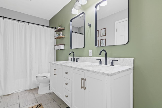 full bath featuring double vanity, curtained shower, a sink, and toilet