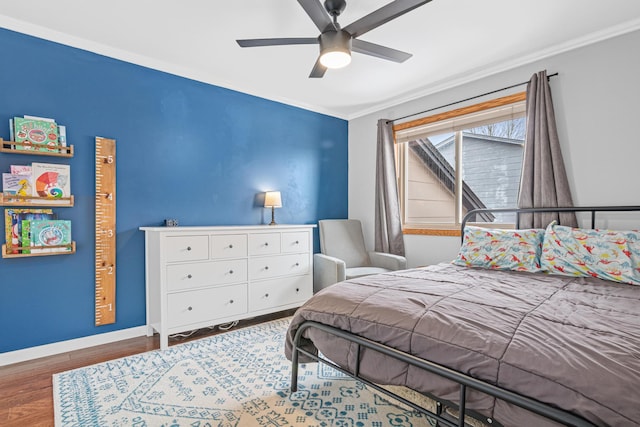 bedroom with ceiling fan, ornamental molding, wood finished floors, and baseboards