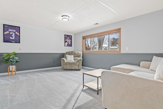 sitting room with carpet, visible vents, and baseboards