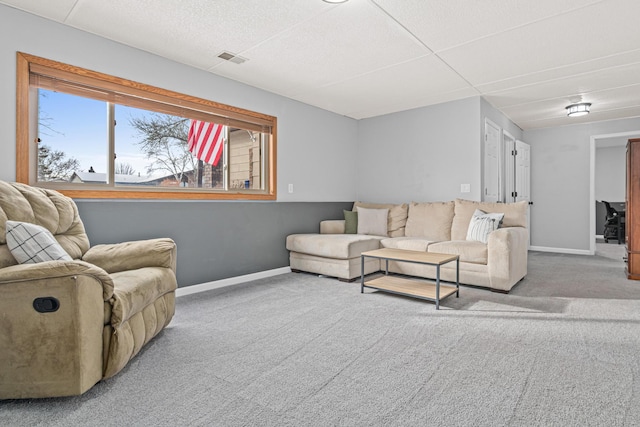 living area featuring carpet floors, visible vents, and baseboards