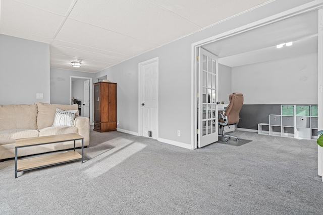 living room featuring carpet and baseboards