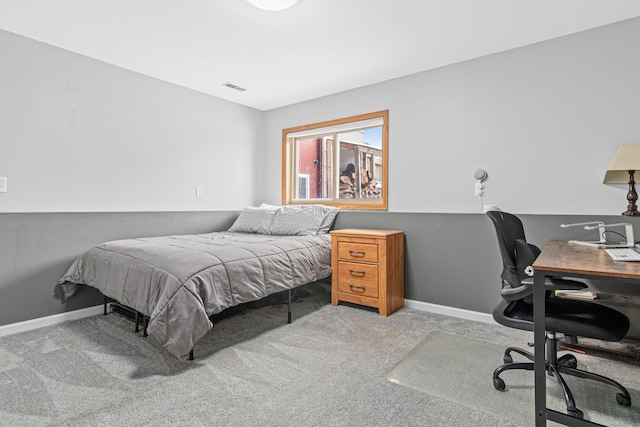 carpeted bedroom with visible vents and baseboards