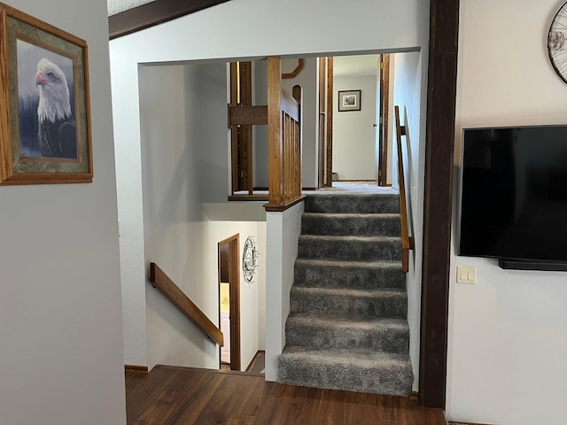 stairway with hardwood / wood-style flooring and vaulted ceiling