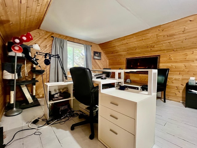 home office featuring wooden walls, lofted ceiling, and light hardwood / wood-style floors