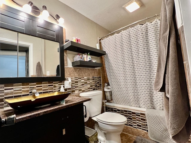 full bathroom with a textured ceiling, backsplash, shower / bath combo with shower curtain, vanity, and toilet