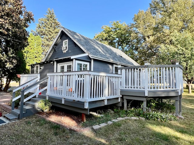 back of house featuring a yard and a wooden deck