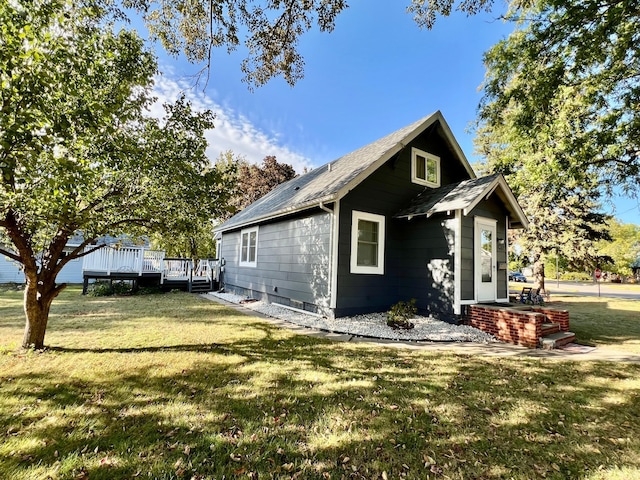 view of home's exterior featuring a lawn and a wooden deck