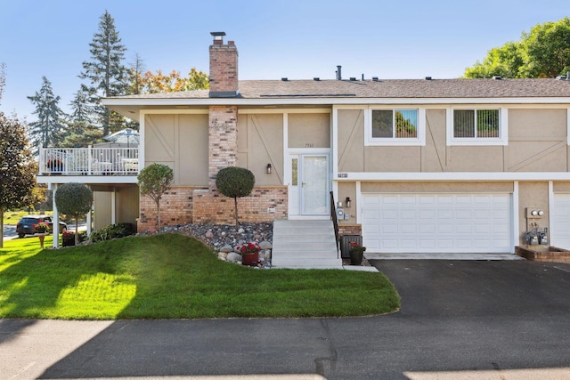 view of front of property with a garage and a front lawn