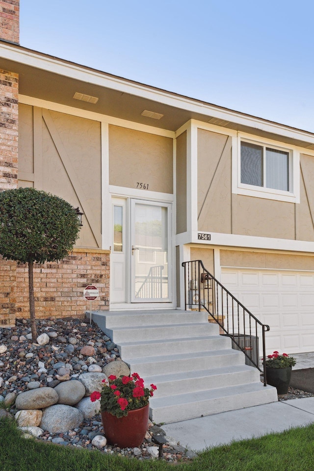 doorway to property with a garage