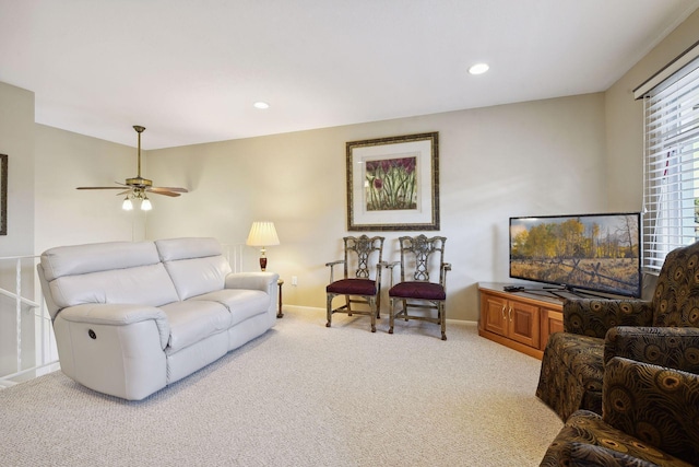 carpeted living room with ceiling fan