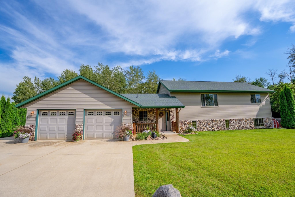 view of front of property with a front lawn and a garage