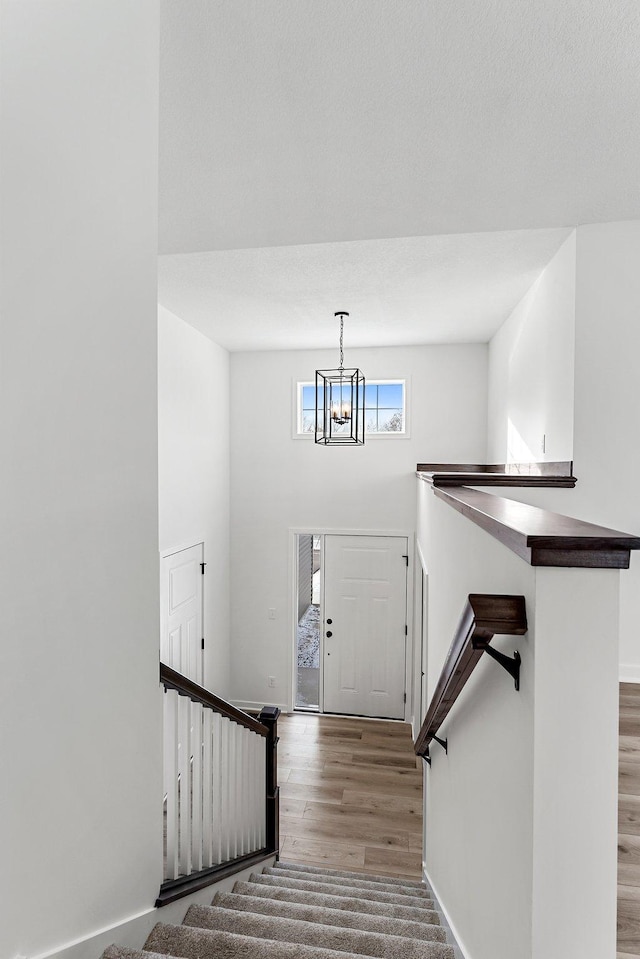 entrance foyer with hardwood / wood-style flooring and a notable chandelier