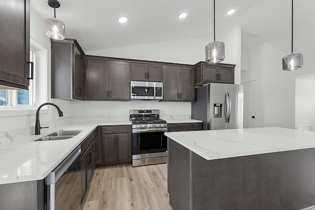 kitchen with sink, hanging light fixtures, and appliances with stainless steel finishes