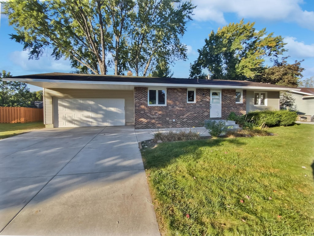 single story home with a garage and a front yard