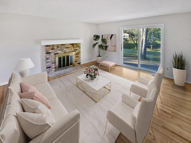 living room with light hardwood / wood-style flooring and a brick fireplace