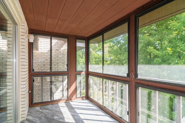 unfurnished sunroom featuring wooden ceiling