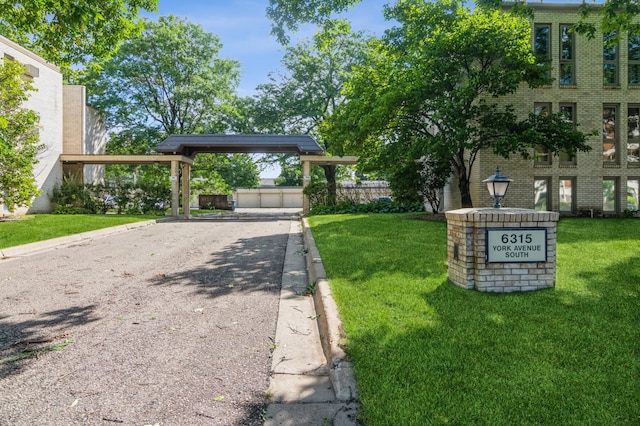 view of front of home with a front yard and a carport