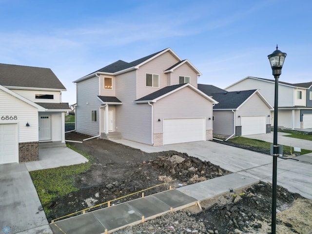 view of front of house with concrete driveway and a garage