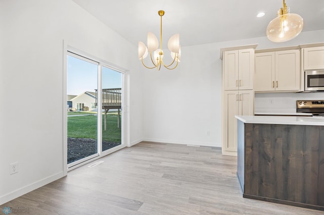 kitchen with appliances with stainless steel finishes, plenty of natural light, and light wood-type flooring