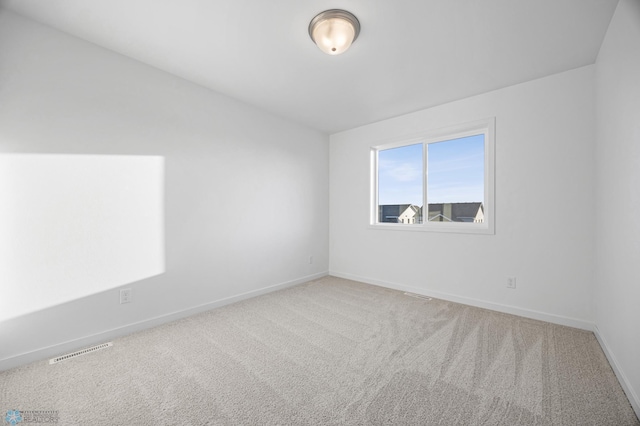 unfurnished room featuring carpet floors and baseboards