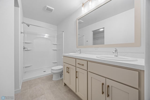 bathroom featuring toilet, double vanity, a shower, and tile patterned floors
