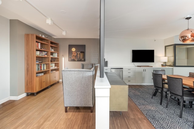 living area with baseboards and light wood-style flooring