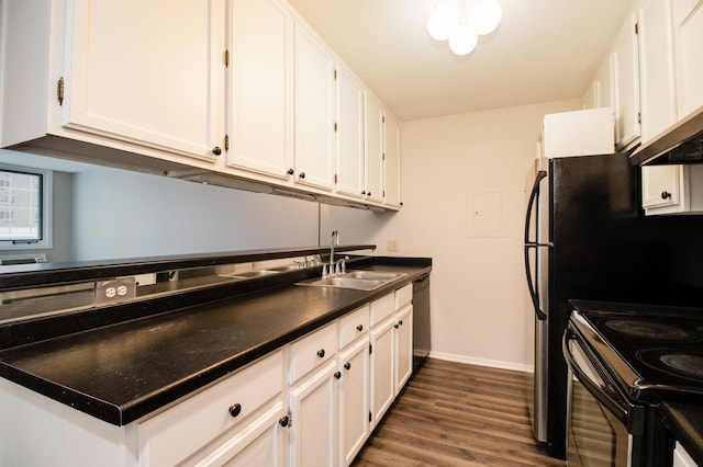 kitchen featuring a sink, white cabinetry, and baseboards
