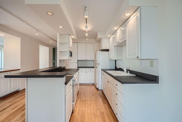 kitchen featuring white cabinetry, sink, and light hardwood / wood-style flooring