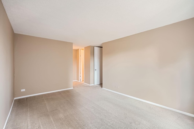 empty room featuring carpet floors and a textured ceiling