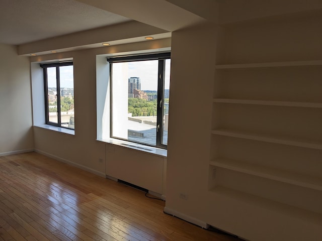 spare room with hardwood / wood-style flooring