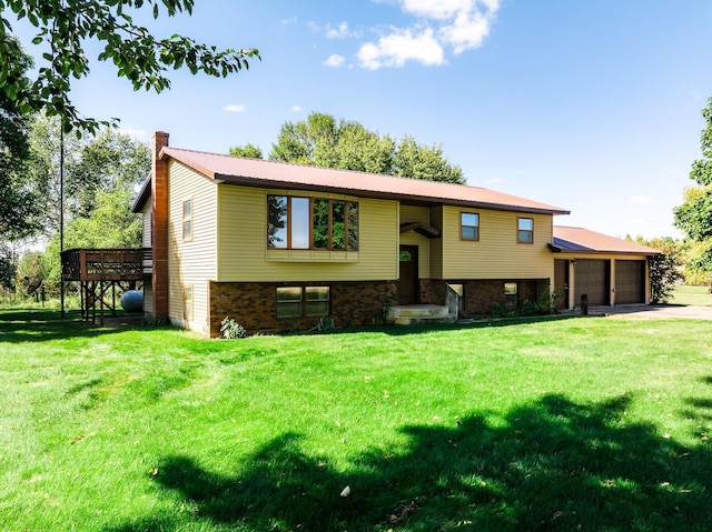 21623 243rd Ave, Long Prairie, MN 56347 - split foyer home with driveway, a chimney, an attached garage, a front lawn, and metal roof