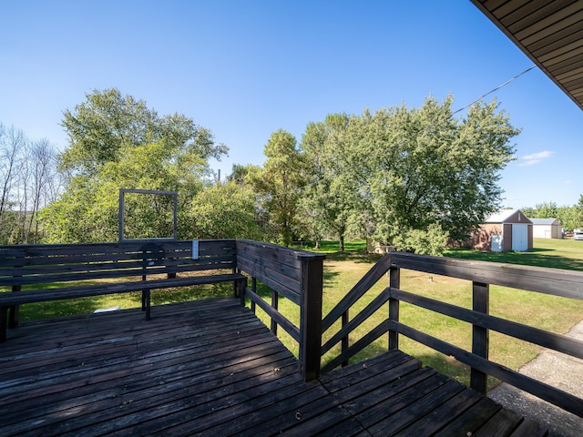 wooden deck featuring a storage shed and a yard