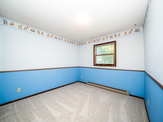 empty room featuring carpet floors and a baseboard heating unit