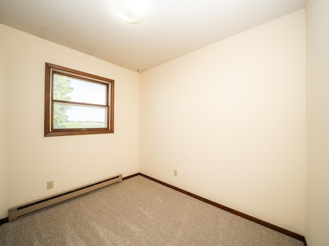 unfurnished room featuring carpet and a baseboard radiator