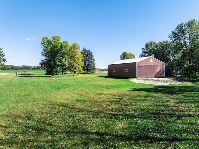 view of yard featuring an outbuilding and a rural view