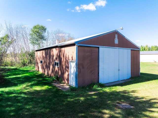 view of outbuilding with a lawn