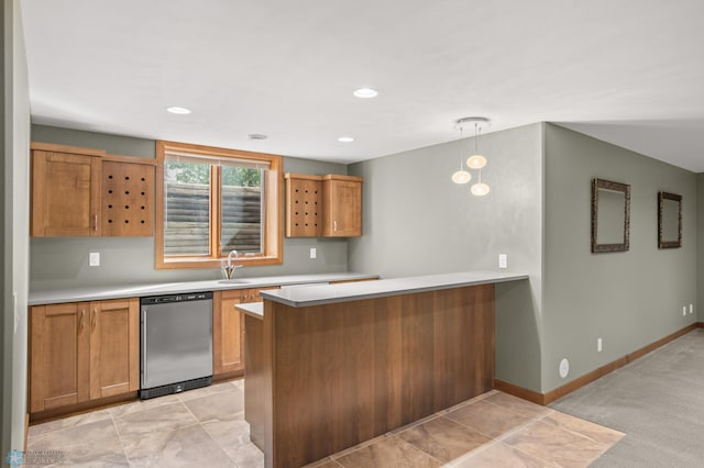 kitchen with kitchen peninsula, dishwasher, pendant lighting, and sink