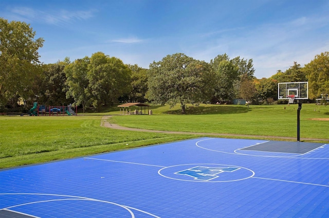 view of basketball court with a lawn and a playground