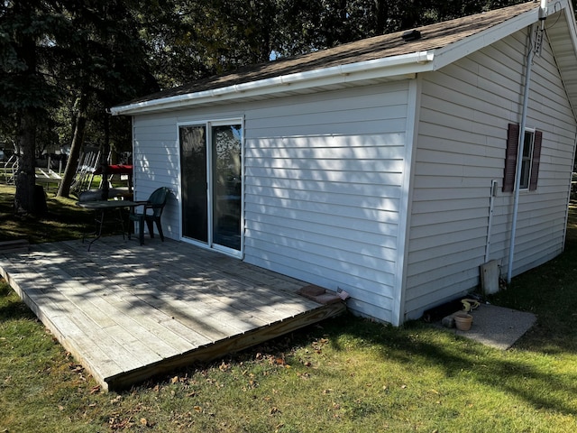 exterior space with a lawn and wooden walls