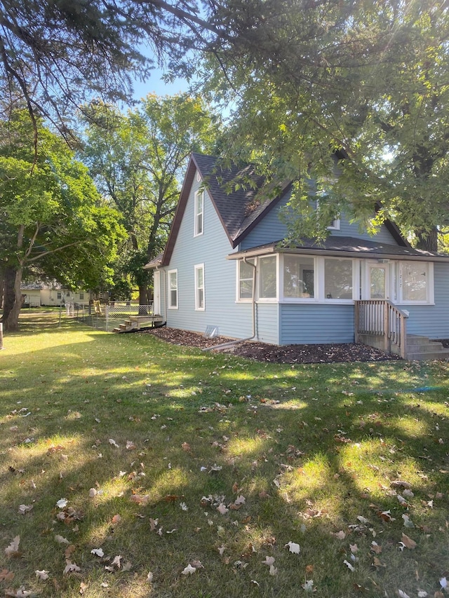 view of property exterior with a lawn